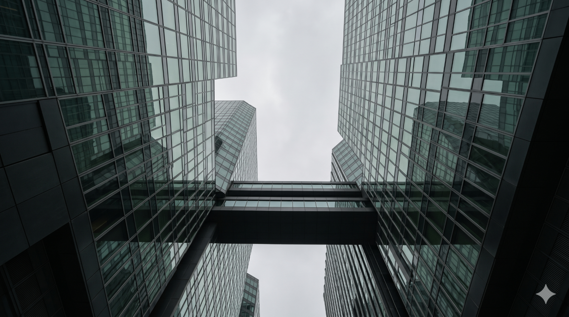 Two modern glass office towers connected by a skybridge